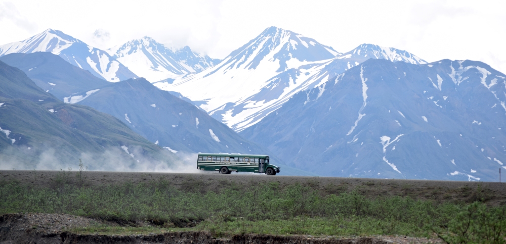 Denali Bus with Dust Trail and Mountains